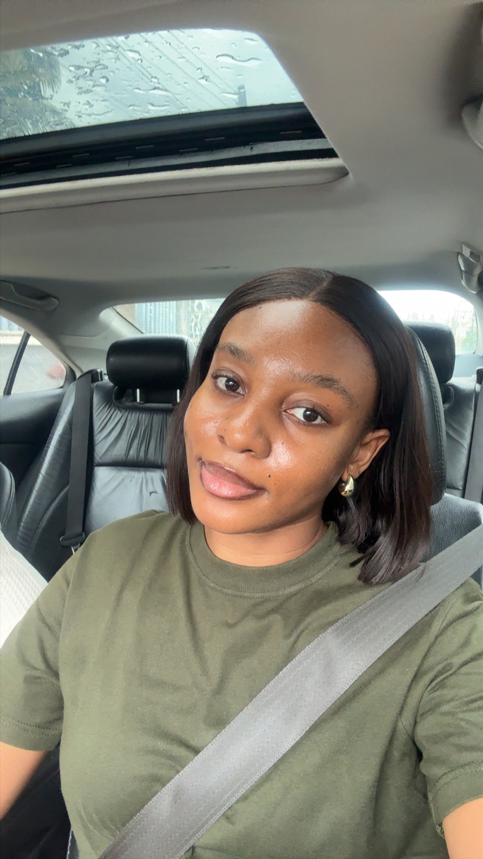 Close-up selfie of Stephanie wearing an olive-green top.